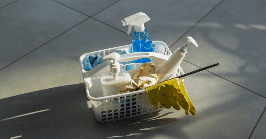Essential home cleaning products arranged neatly on a kitchen counter in a Dubai apartment