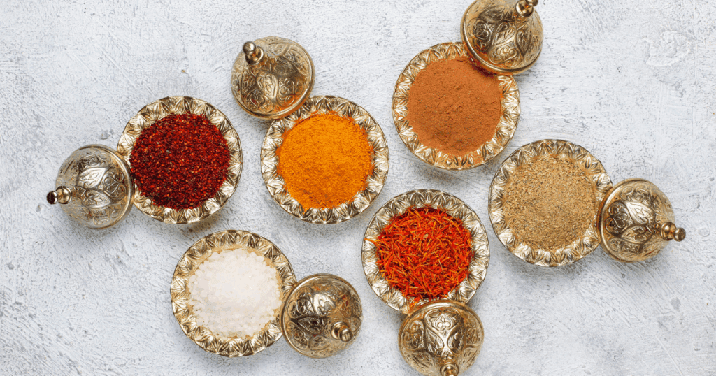 Authentic Middle Eastern ingredients like za’atar, tahini, sumac, and pomegranate molasses on a kitchen table